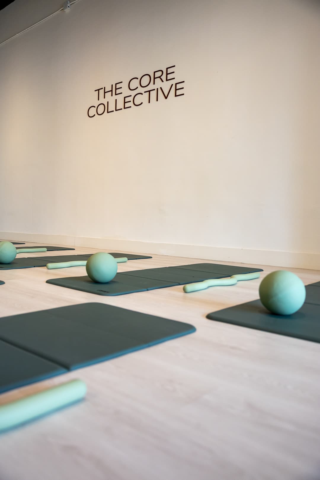Mats and balls in rows beneath the wordmark
